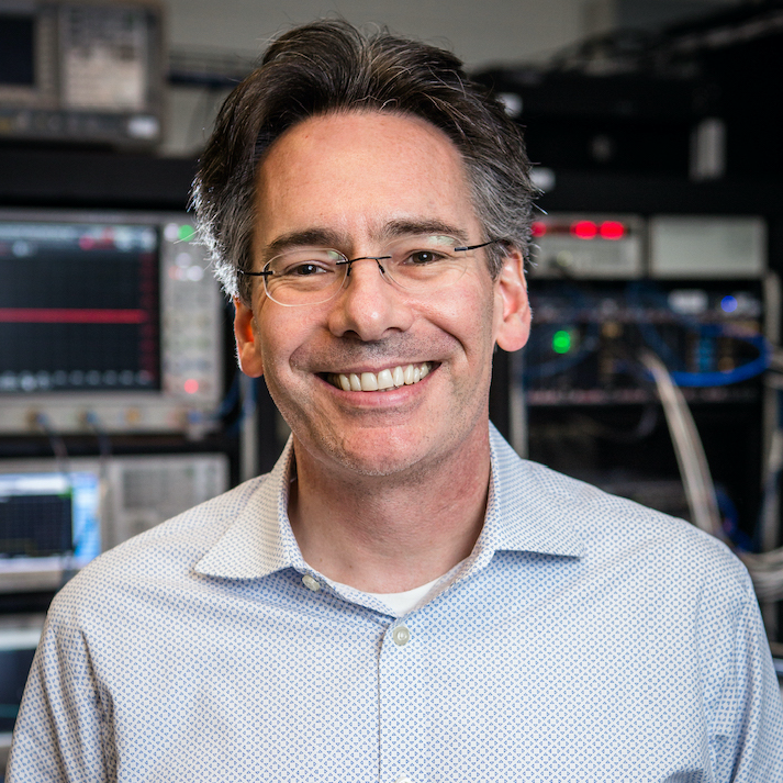 william oliver standing in front of lab equipment