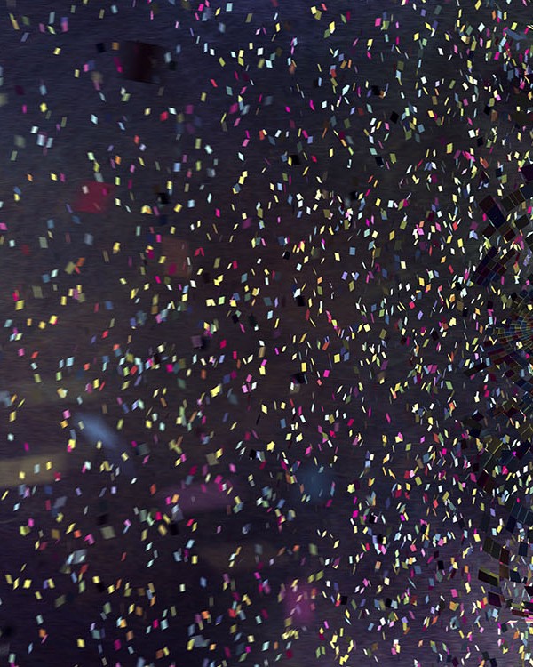 A conceptual images of thousands of multi coloured squares all moving in mid air against a black background, coalescing to form a the profile of a head