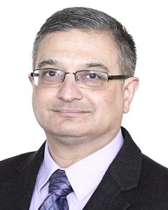 vivek dave a male with glasses in suit