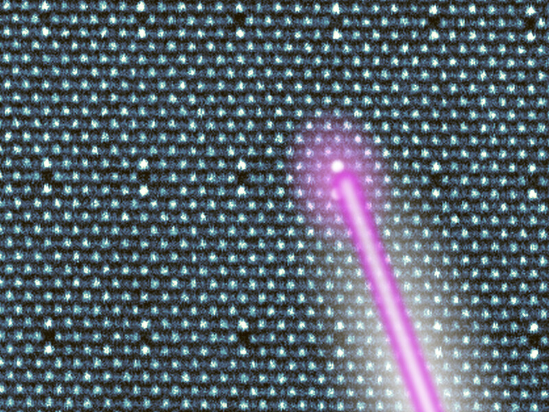 A laser beam lights up a specific atom in a giant crystal lattice of atoms.